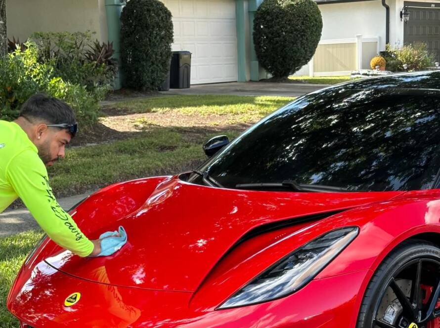 Deep, glossy car paint protected with a professional ceramic coating by Twins Detailing Orlando, showing extreme hydrophobic water beading