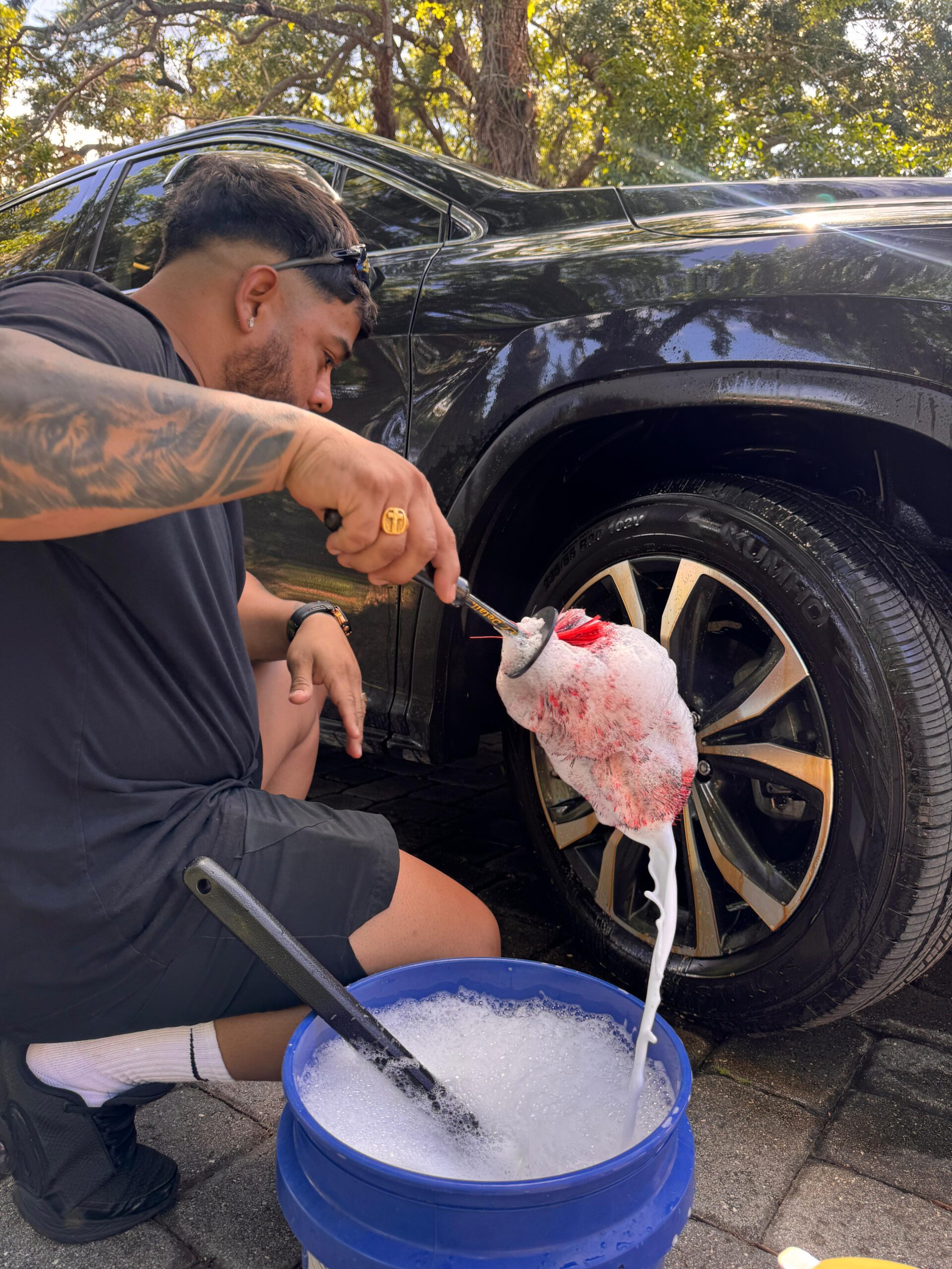 Andres Tonitto — co-founder of Twins Detailing Orlando, polishing a vehicle